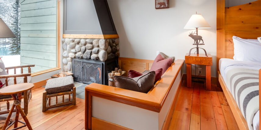 A sofa sitting beside a fireplace within one of the lodge's cabins.