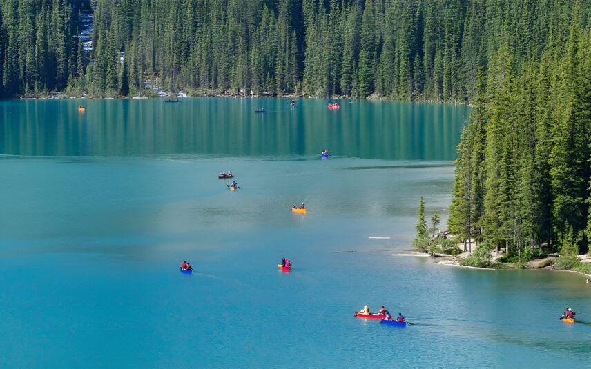 Long far off shot of canoes on Moraine Lake.