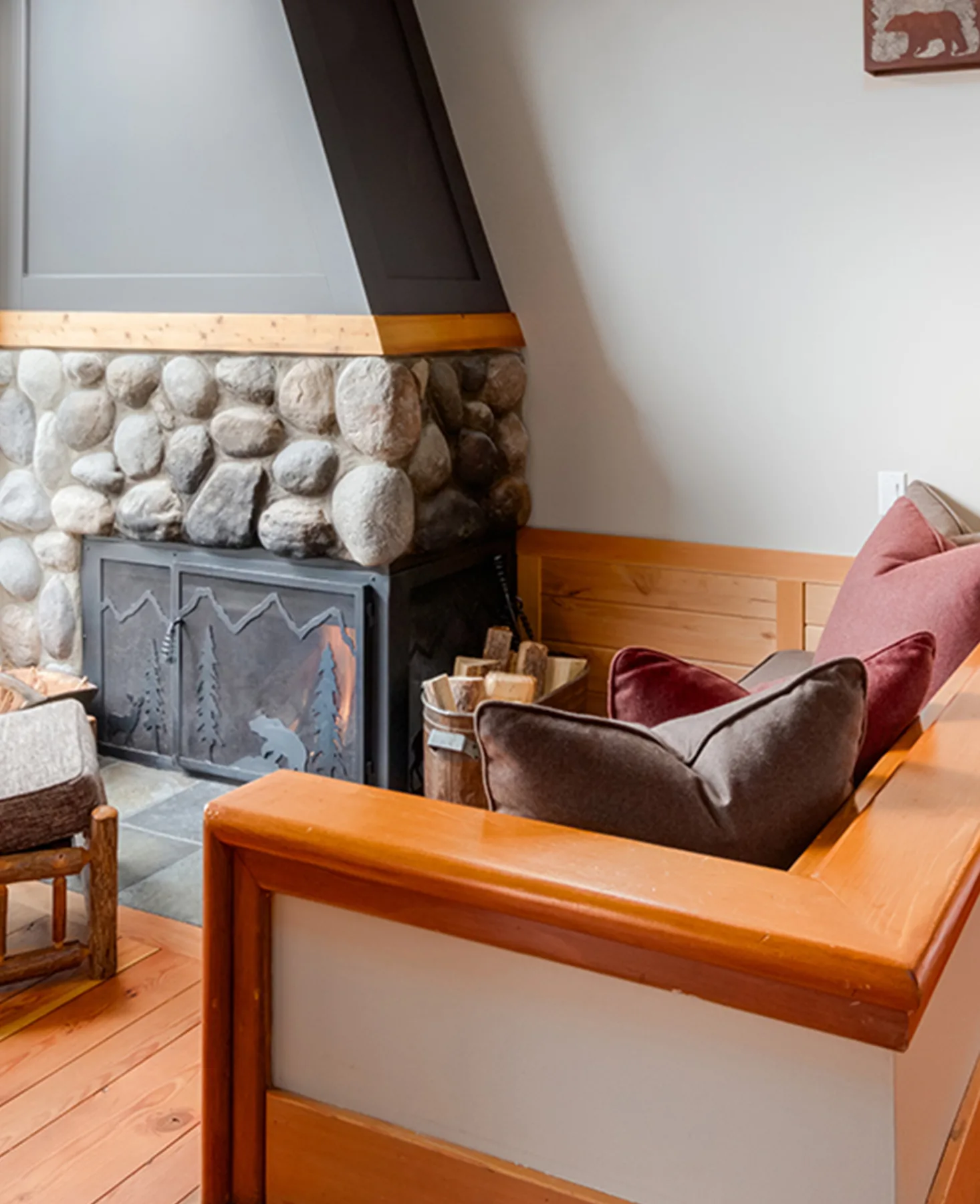 A sofa sitting beside a fireplace within one of the lodge's cabins.